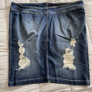 Destructed denim skirt with rear zipper.
